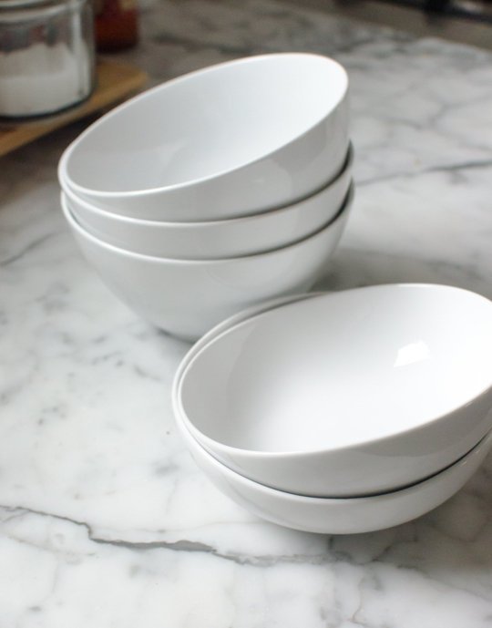 Two stacks of white bowls